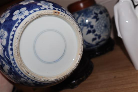 Two Chinese blue and white jars and covers and a pair of hardwood stands